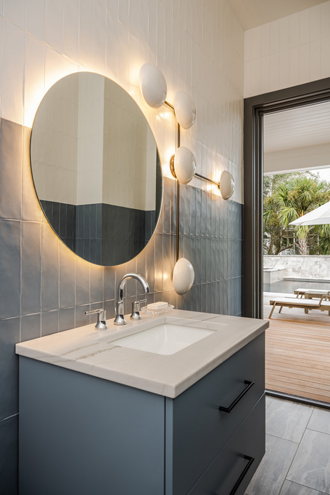 This is an example of a contemporary cloakroom in Charleston with flat-panel cabinets, blue cabinets, ceramic tiles, white worktops and a floating vanity unit.