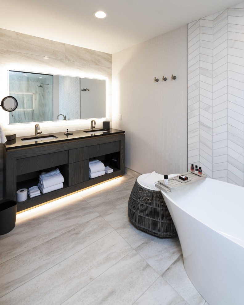 Example of a mid-sized trendy master white tile and ceramic tile black floor, double-sink and ceramic tile bathroom design in Minneapolis with open cabinets, brown cabinets, white walls, a hinged shower door, black countertops and a built-in vanity