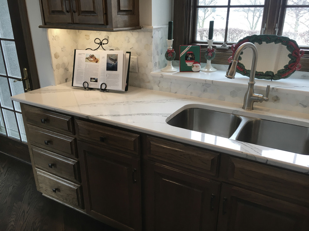Inspiration for a large transitional u-shaped medium tone wood floor open concept kitchen remodel with an undermount sink, recessed-panel cabinets, distressed cabinets, quartz countertops, multicolored backsplash, mosaic tile backsplash, stainless steel appliances and an island