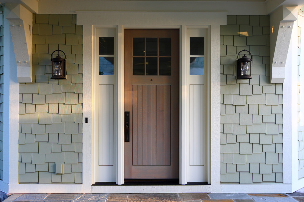 Photo of a large traditional front door in Grand Rapids with a single front door and a medium wood front door.
