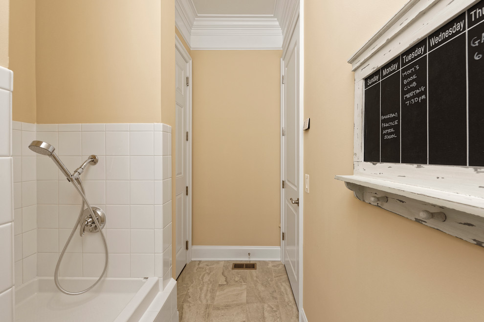 Photo of a mid-sized transitional single-wall utility room in DC Metro with beige walls and slate floors.