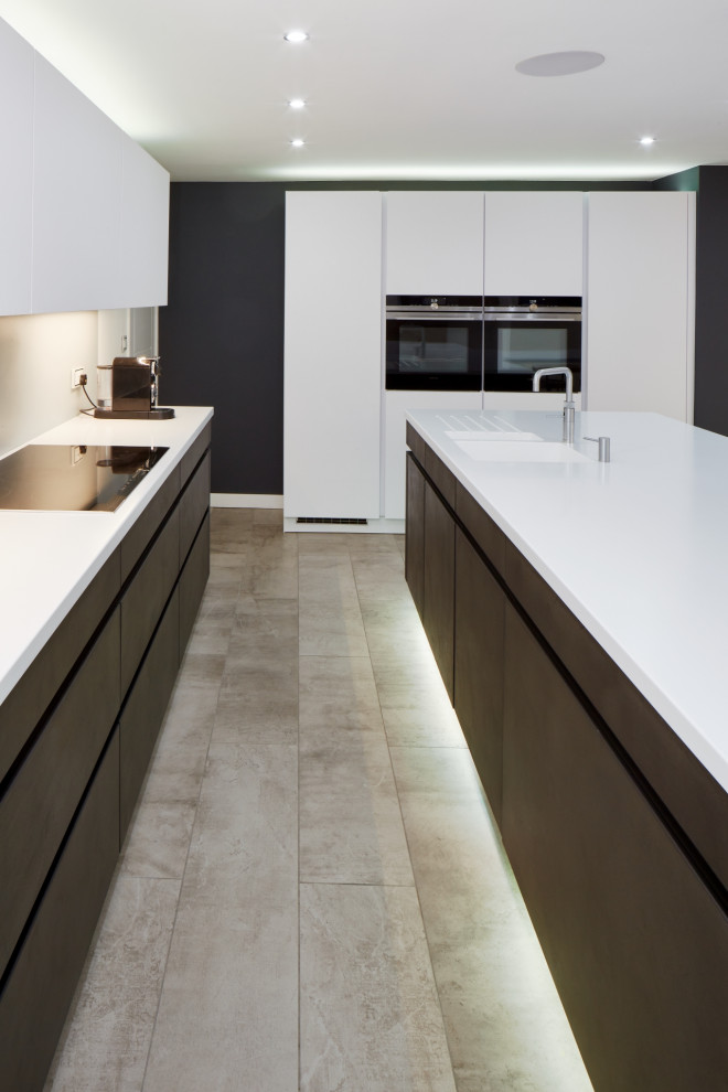Design ideas for a mid-sized contemporary eat-in kitchen in Other with an integrated sink, flat-panel cabinets, brown cabinets, solid surface benchtops, grey splashback, glass sheet splashback, panelled appliances, with island and white benchtop.