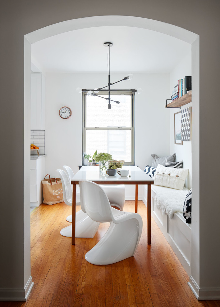 Kitchen/dining room combo - small transitional light wood floor and white floor kitchen/dining room combo idea in Chicago with white walls