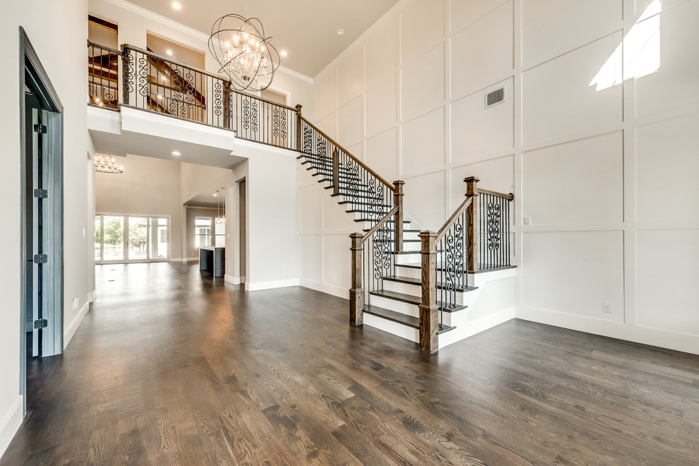 Inspiration for a large transitional foyer in Dallas with grey walls, medium hardwood floors, a double front door, a metal front door and brown floor.