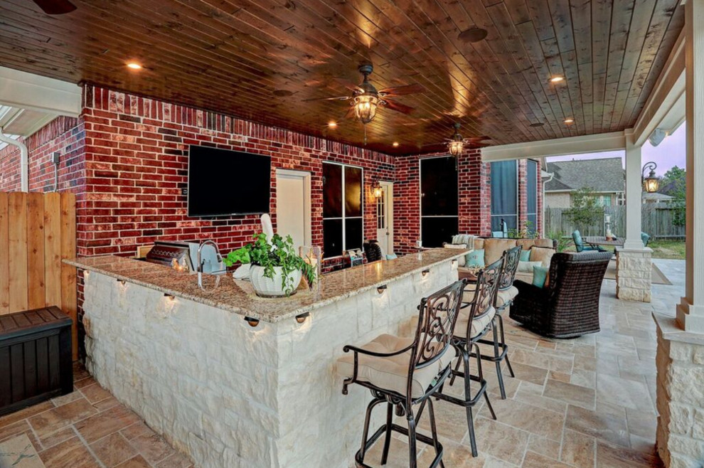 Inspiration for a mid-sized timeless backyard tile patio kitchen remodel in Houston with a roof extension