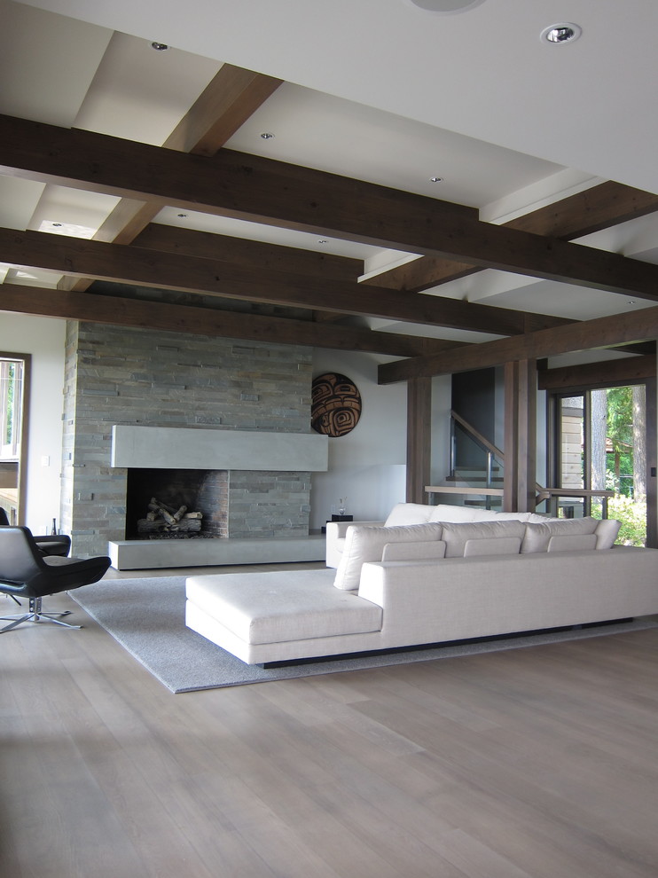 Inspiration for a large contemporary formal open concept living room in Vancouver with white walls, a standard fireplace, light hardwood floors, a stone fireplace surround and beige floor.