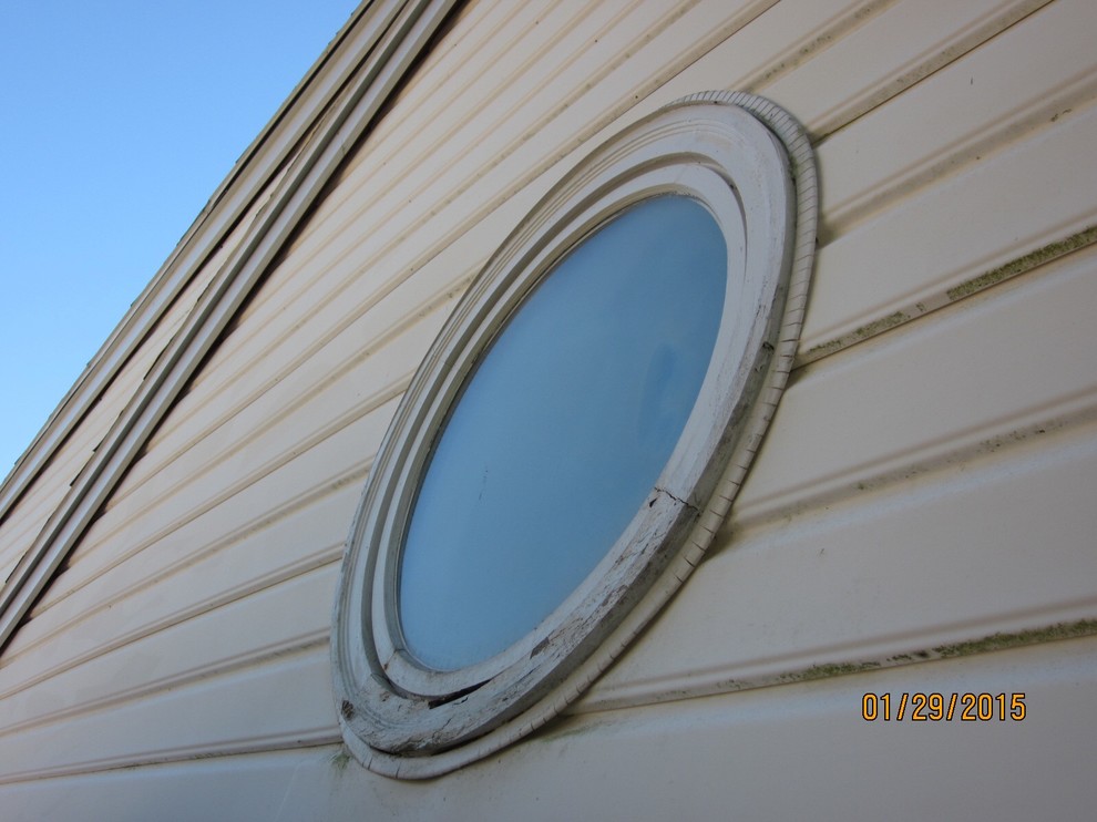 Round wood window in shower is rotting