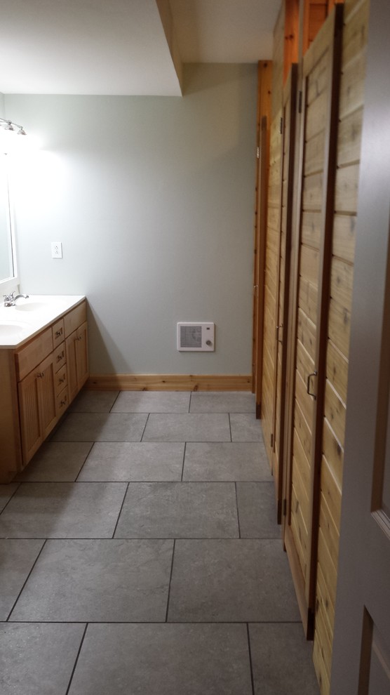 Expansive country kids bathroom in Cincinnati with a double shower, an urinal, gray tile, porcelain tile, blue walls and porcelain floors.