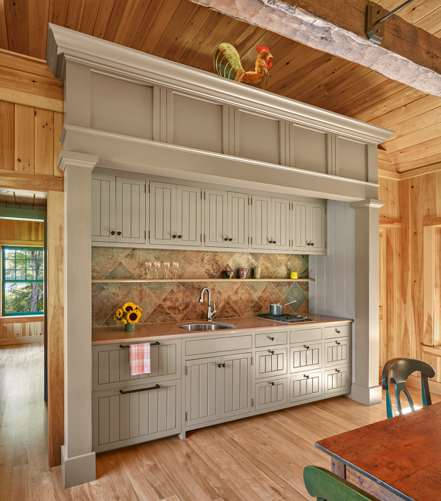 Inspiration for a farmhouse single-wall wet bar in Boston with a built-in sink, flat-panel cabinets, beige cabinets, brown splashback, ceramic splashback, medium hardwood flooring, brown floors and brown worktops.