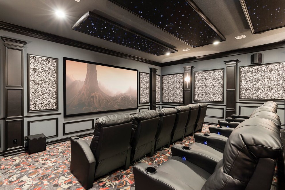 Mediterranean enclosed home theatre in Orlando with multi-coloured walls, carpet, a projector screen and multi-coloured floor.