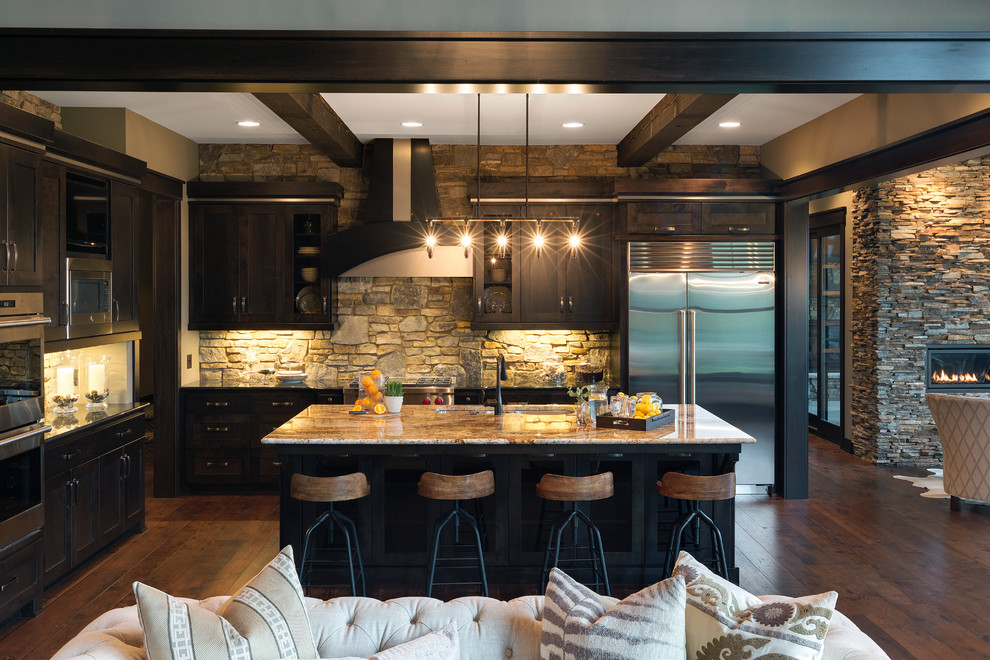 Country l-shaped kitchen in Minneapolis with an undermount sink, shaker cabinets, black cabinets, multi-coloured splashback, dark hardwood floors and with island.