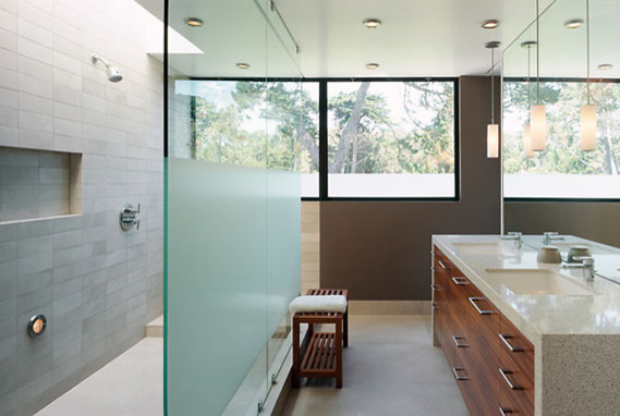 This is an example of a small modern master bathroom in San Francisco with a drop-in sink, flat-panel cabinets, dark wood cabinets, engineered quartz benchtops, an open shower, gray tile, stone tile, brown walls and concrete floors.