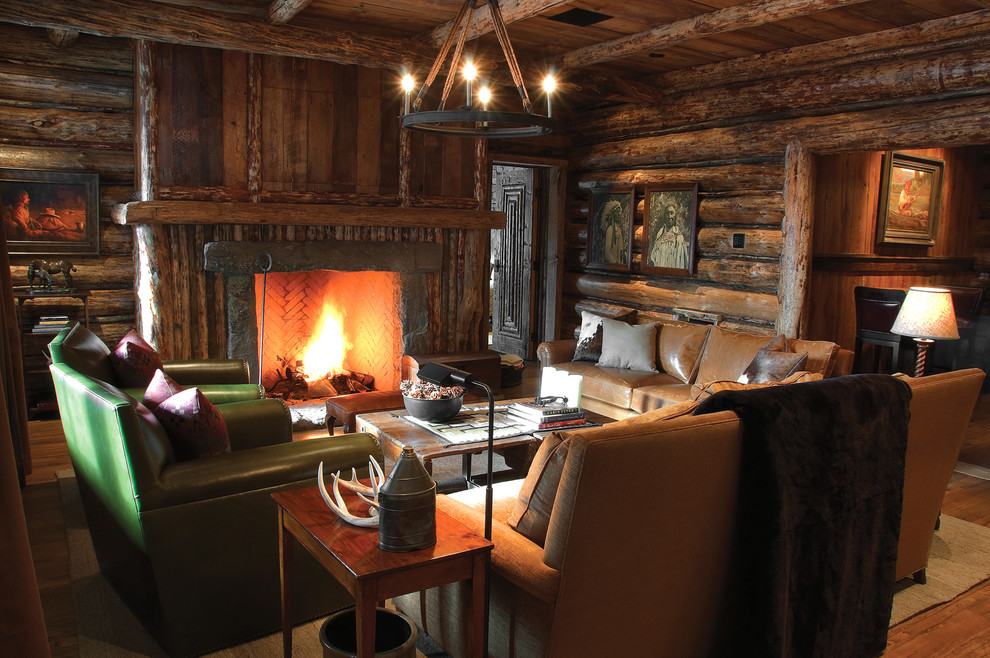 Design ideas for a country family room in Other with brown walls, dark hardwood floors, a standard fireplace and a wood fireplace surround.