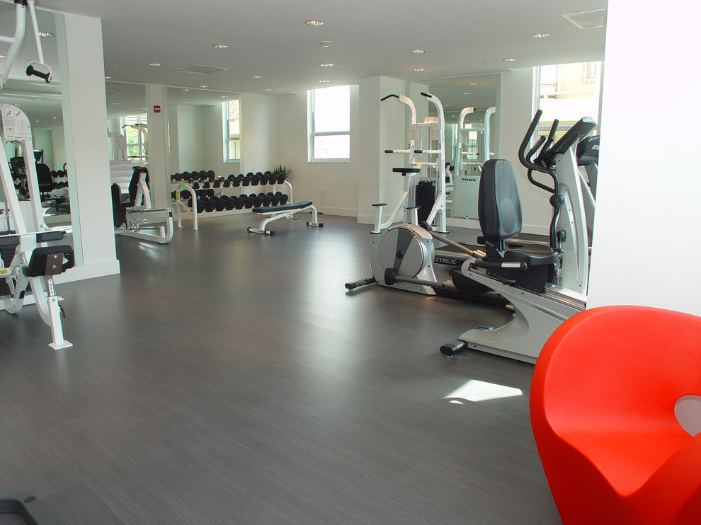 This is an example of a large contemporary home weight room in Miami with white walls, vinyl floors and grey floor.