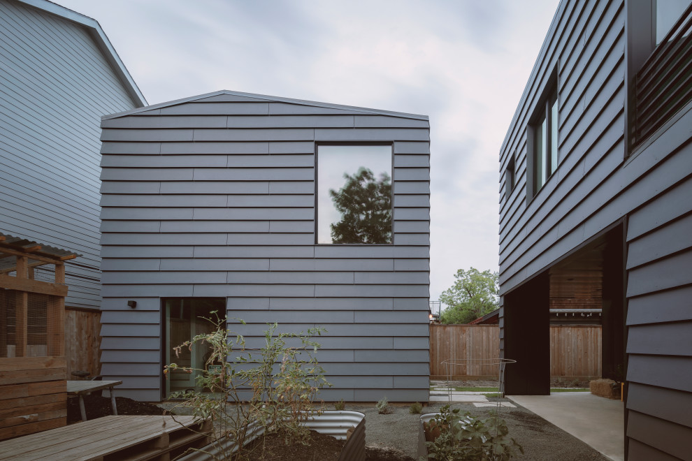 Inspiration for a medium sized and gey contemporary two floor detached house in Houston with concrete fibreboard cladding, a pitched roof, a metal roof, a black roof and shiplap cladding.