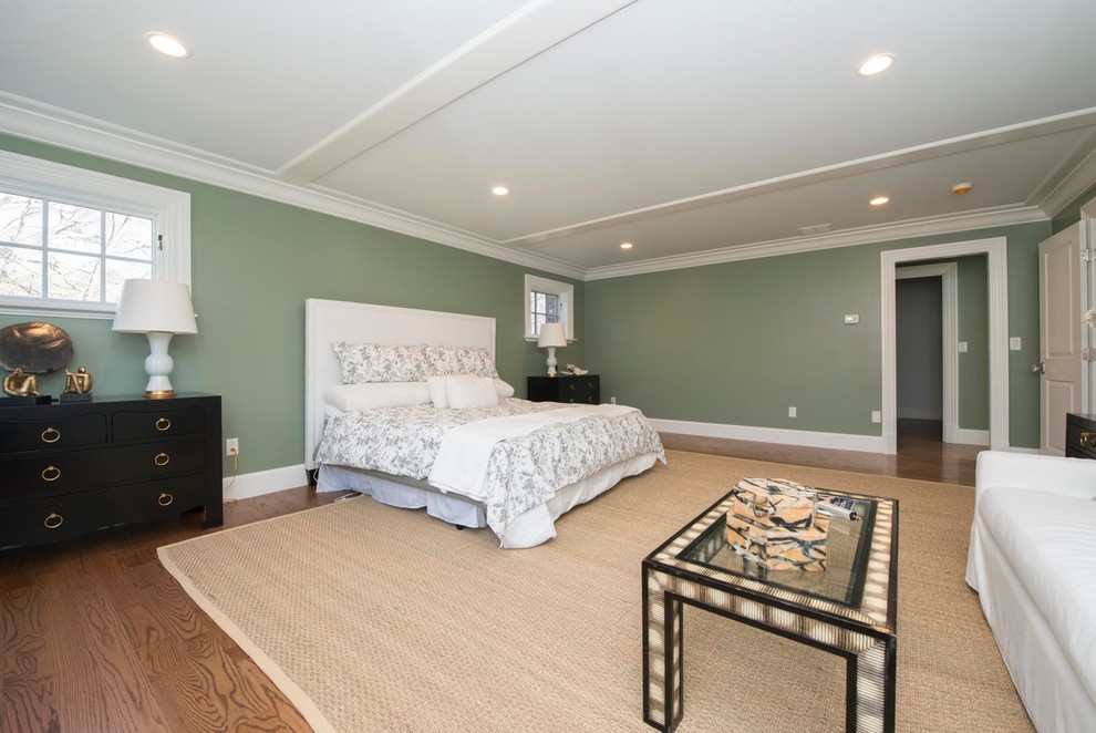 Traditional master bedroom in Boston with green walls and carpet.