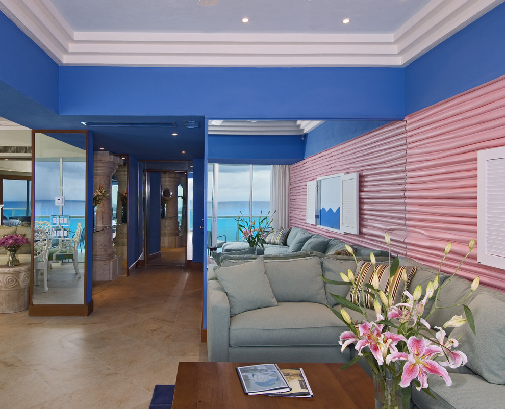 Inspiration for a tropical living room in Other with blue walls.