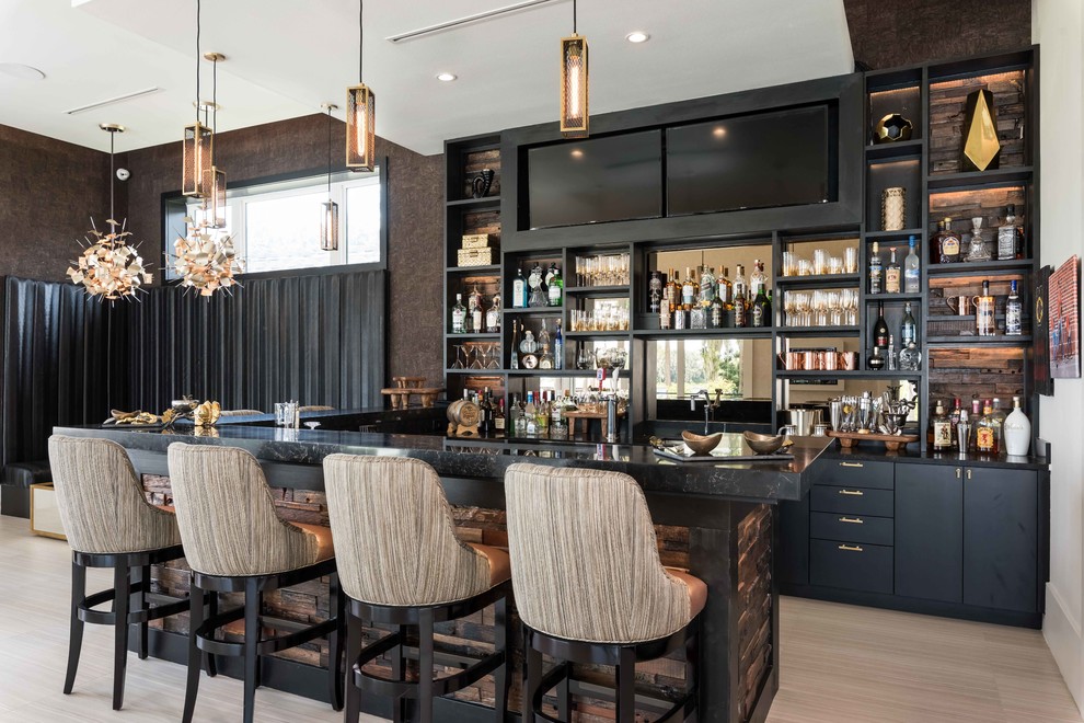 Inspiration for a large contemporary u-shaped seated home bar in Orlando with black cabinets, mirror splashback and flat-panel cabinets.