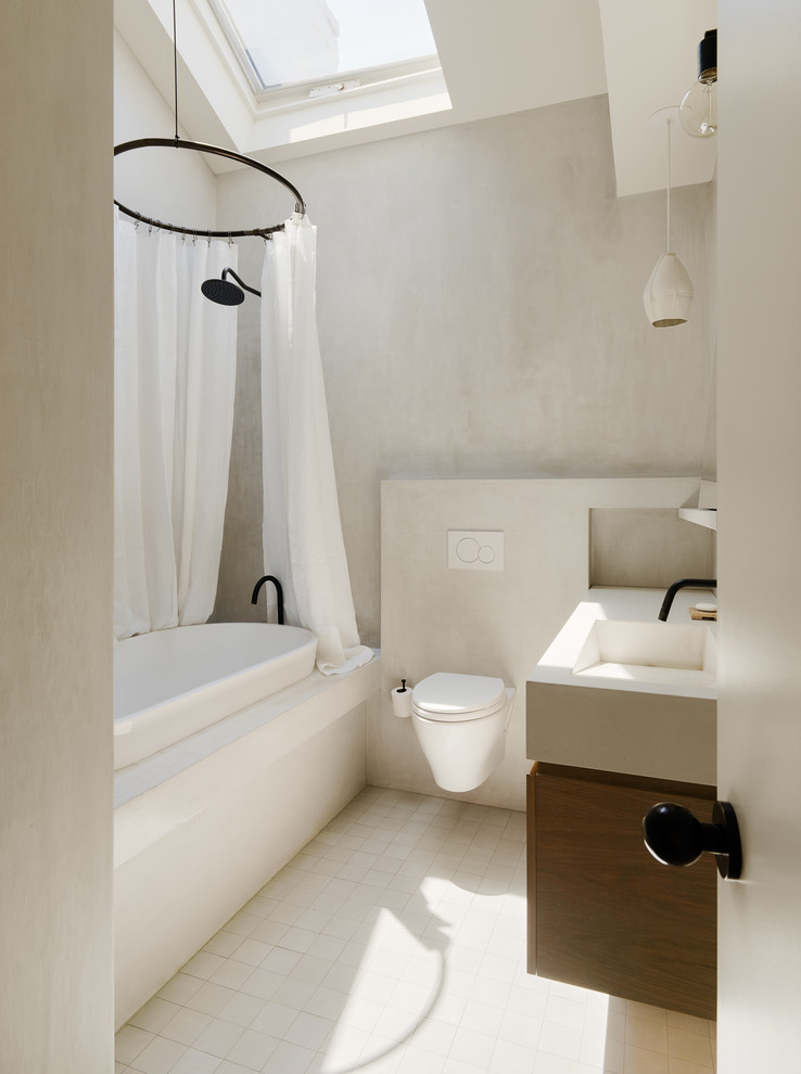 Inspiration for a mid-sized contemporary 3/4 mosaic tile floor drop-in bathtub remodel in New York with dark wood cabinets, an integrated sink, flat-panel cabinets, a bidet, white walls, solid surface countertops and white countertops
