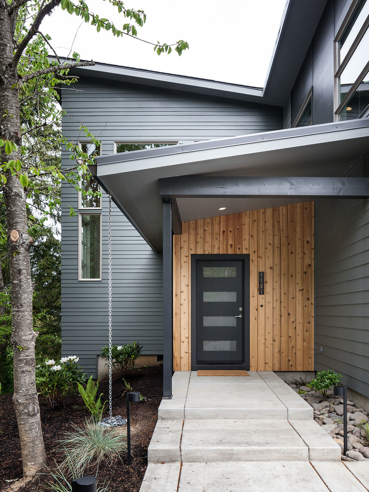 This is an example of a large modern two-storey grey exterior in Portland with mixed siding.