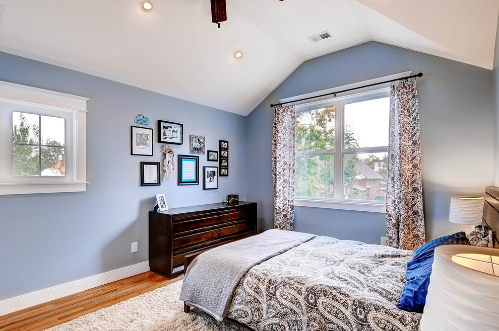 Inspiration for a mid-sized transitional master bedroom in Denver with blue walls, medium hardwood floors and no fireplace.