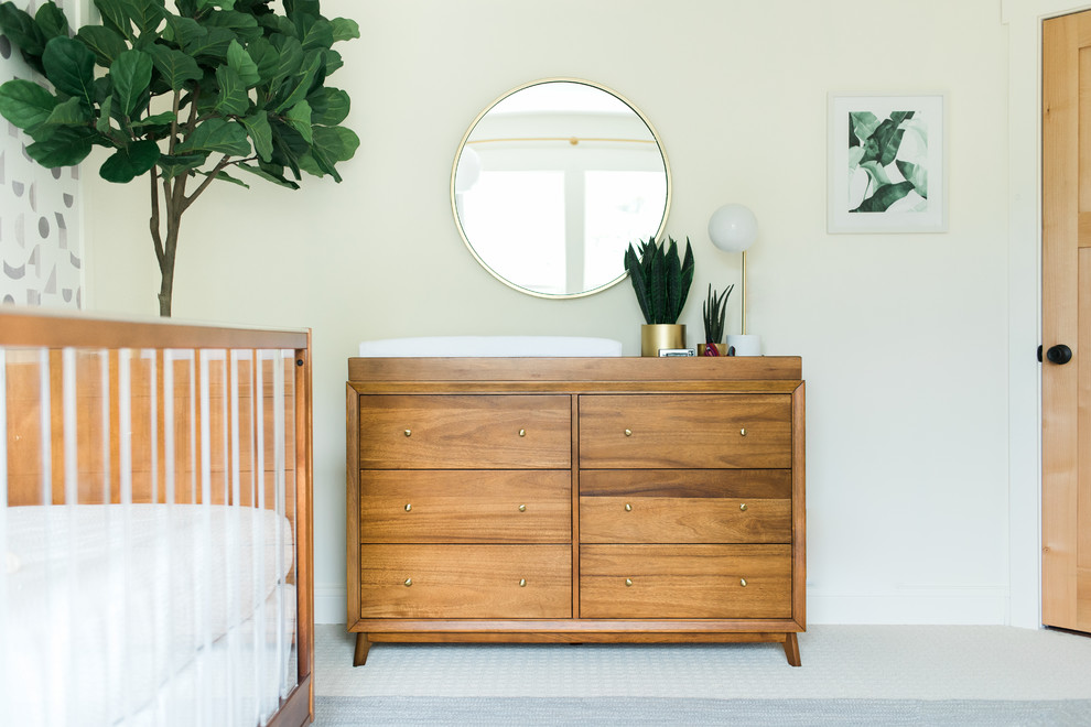 Mid-sized midcentury gender-neutral nursery in Minneapolis with white walls, carpet and grey floor.