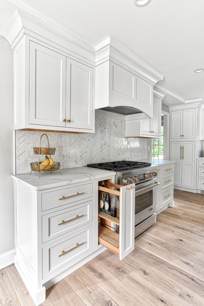 Large transitional kitchen in New York with an undermount sink, white cabinets, quartz benchtops, white splashback, mosaic tile splashback, panelled appliances, white benchtop and shaker cabinets.