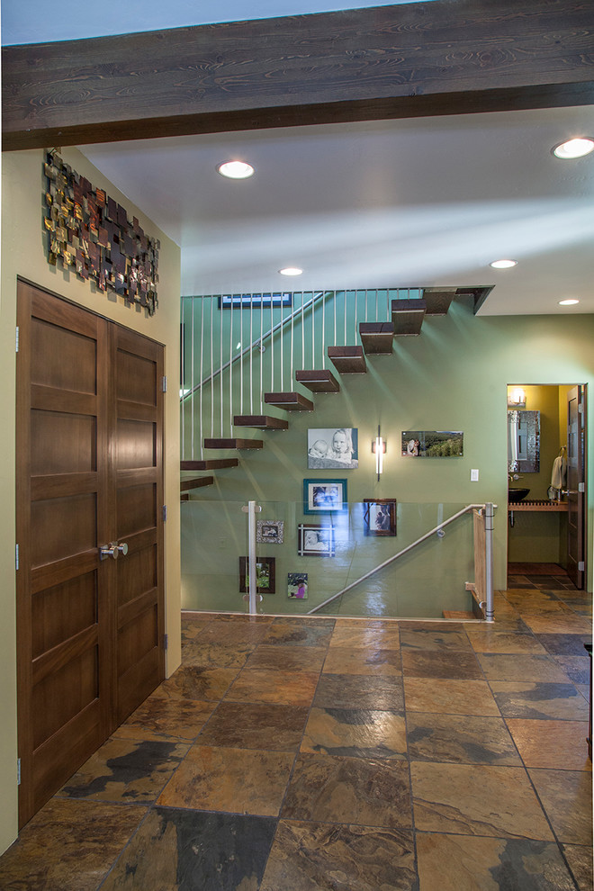 This is an example of a contemporary wood straight staircase in Albuquerque with open risers.