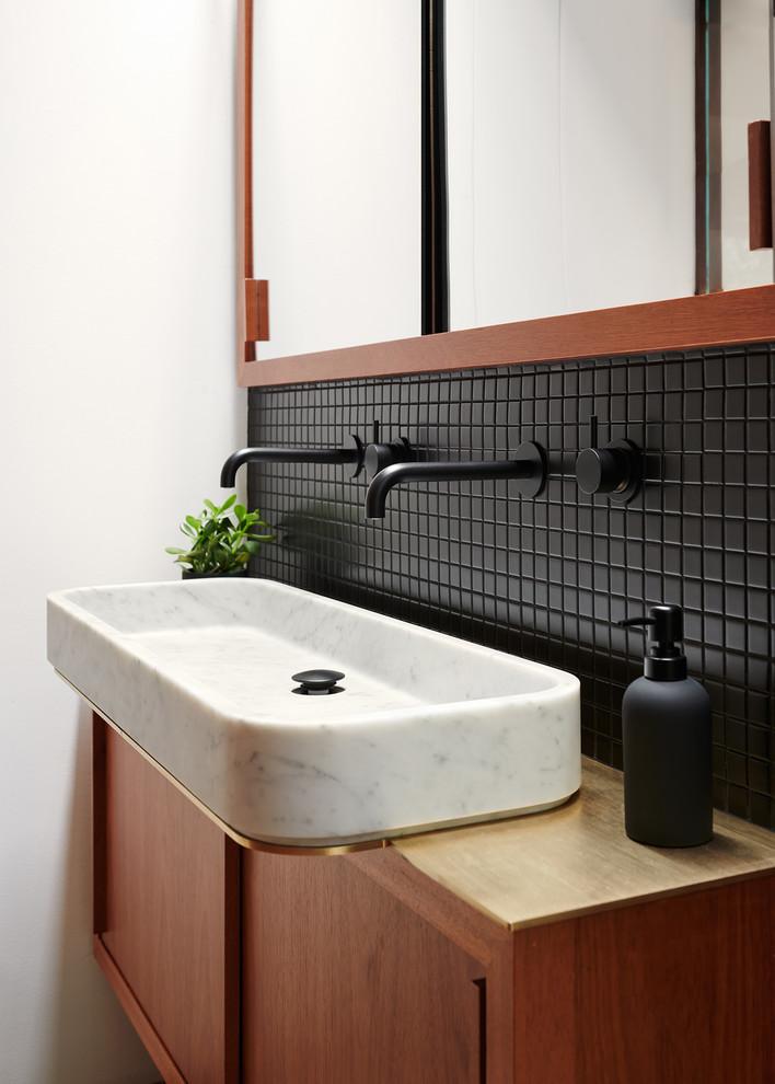 Inspiration for a small contemporary bathroom in San Francisco with flat-panel cabinets, medium wood cabinets, black tile, ceramic tile, white walls, a vessel sink, wood benchtops and brown benchtops.