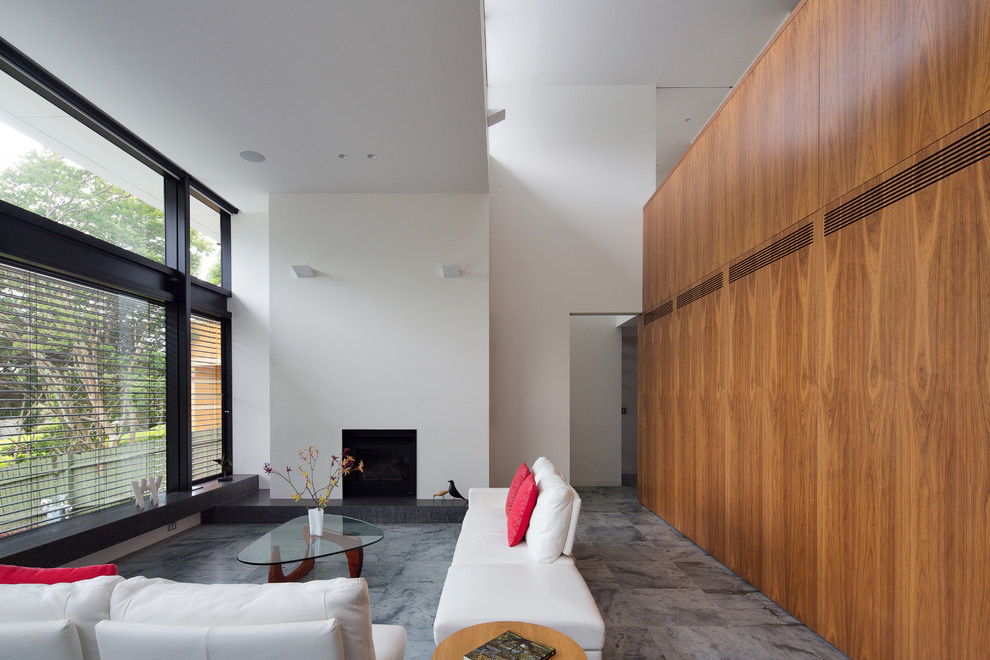 Photo of a large contemporary open concept living room in Sydney with white walls, a standard fireplace, a plaster fireplace surround and no tv.