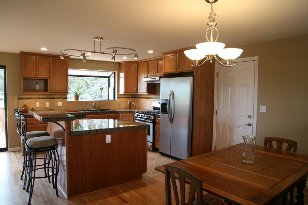 Eat-in kitchen - large light wood floor eat-in kitchen idea in Minneapolis with medium tone wood cabinets, beige backsplash, stone tile backsplash, stainless steel appliances and an island