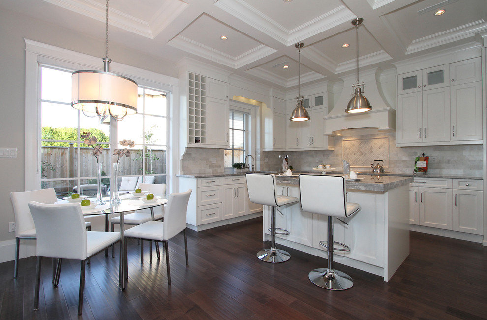 Inspiration for a mid-sized transitional l-shaped dark wood floor eat-in kitchen remodel in Vancouver with shaker cabinets, white cabinets, gray backsplash, stainless steel appliances, an island, granite countertops, stone tile backsplash and a farmhouse sink