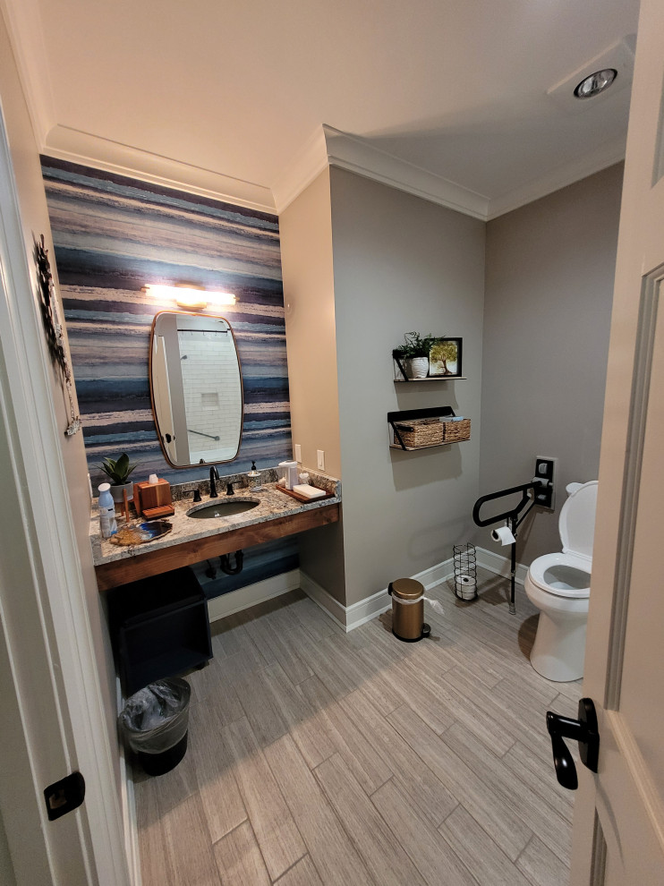 Eclectic bathroom in Atlanta with beaded inset cabinets, vinyl floors and brown floor.