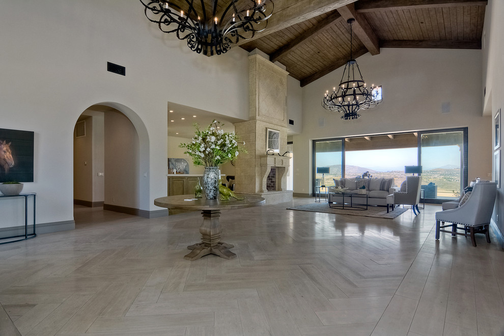 Design ideas for a large transitional entry hall in San Diego with beige walls, limestone floors, a double front door and a dark wood front door.