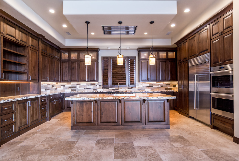 Photo of a large u-shaped open plan kitchen in Salt Lake City with an undermount sink, raised-panel cabinets, dark wood cabinets, granite benchtops, multi-coloured splashback, ceramic splashback, stainless steel appliances, ceramic floors and with island.