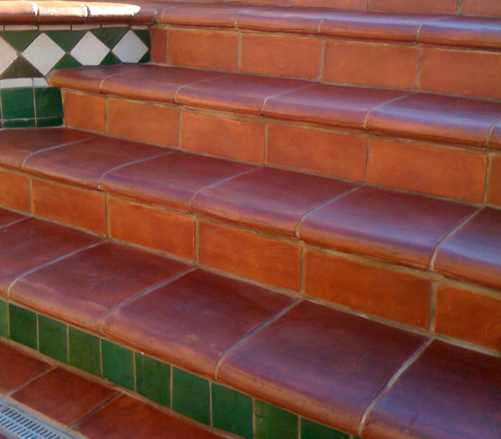 This is an example of a large mediterranean backyard patio in Orange County with tile.