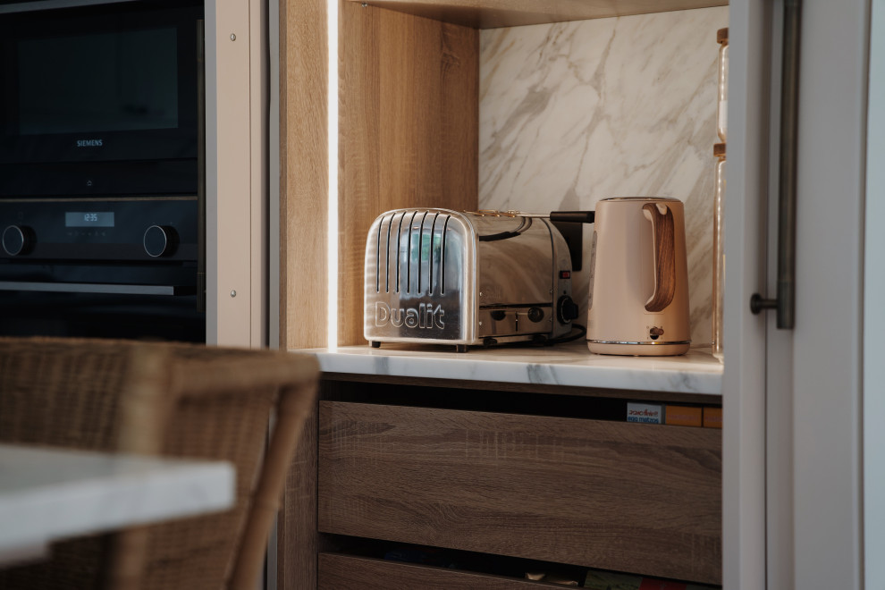 Inspiration for a medium sized traditional l-shaped kitchen in London with a submerged sink, shaker cabinets, pink cabinets, quartz worktops, white splashback, an island and white worktops.