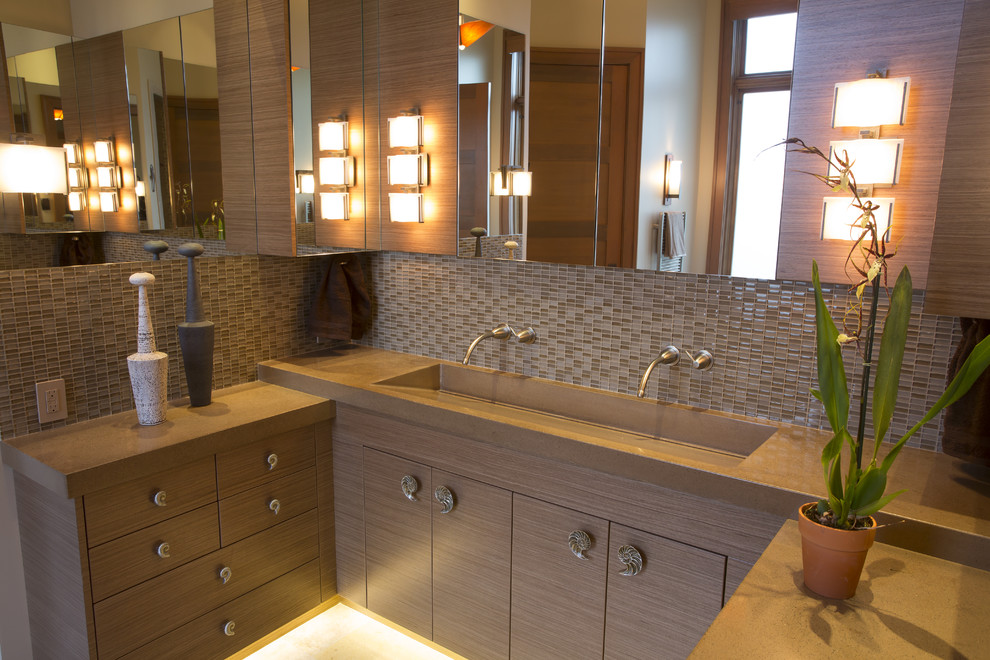 Example of a transitional brown tile and glass tile travertine floor freestanding bathtub design in Seattle with an integrated sink, flat-panel cabinets, medium tone wood cabinets, concrete countertops, a wall-mount toilet and beige walls