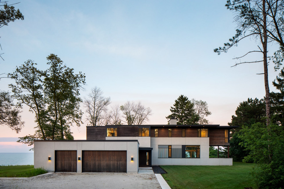 Large trendy two-story exterior home photo in Milwaukee with a black roof