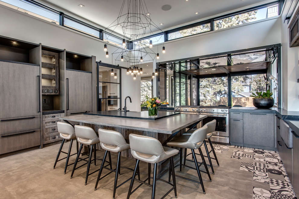 Inspiration for a large contemporary kitchen in Calgary with flat-panel cabinets, concrete benchtops, stainless steel appliances, with island, brown cabinets, window splashback, concrete floors, grey floor and grey benchtop.