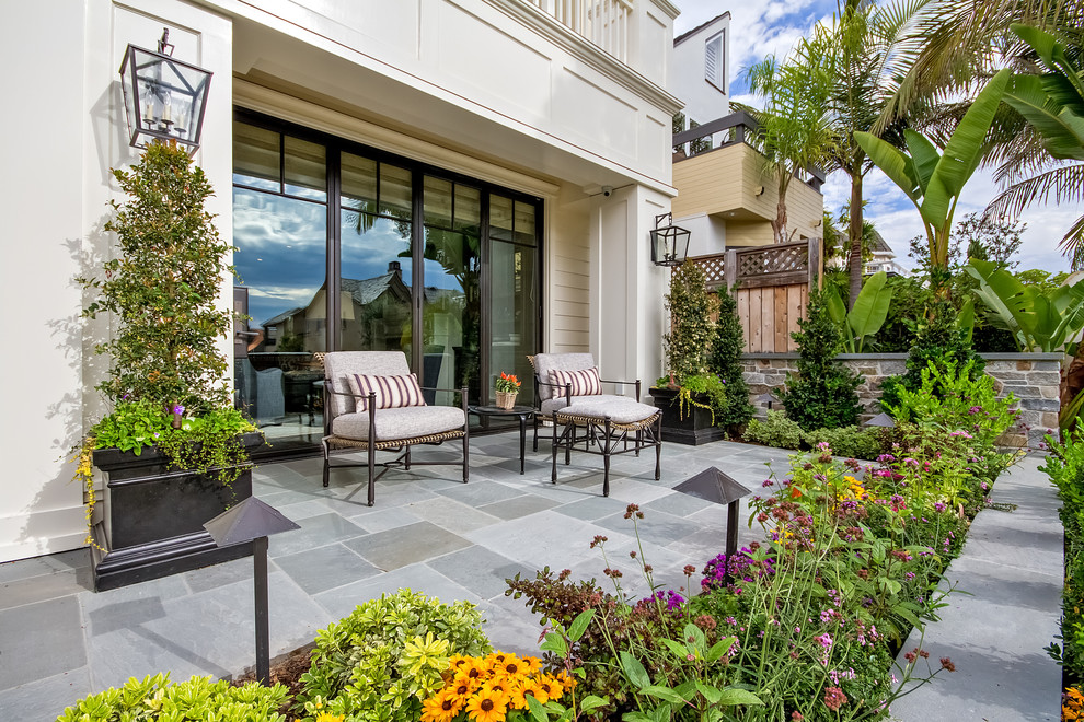 This is an example of a mid-sized traditional patio in Orange County with a container garden and concrete slab.