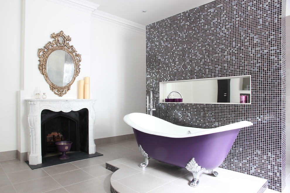 This is an example of a transitional master bathroom in Hampshire with a claw-foot tub, multi-coloured tile, mosaic tile and white walls.