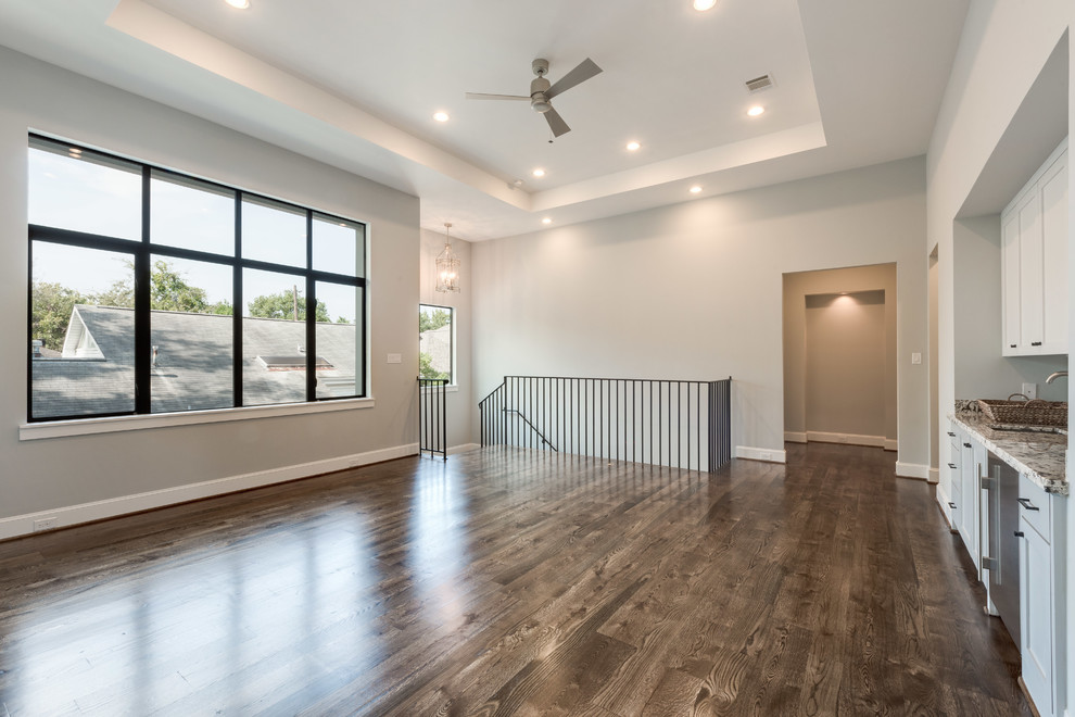 Large transitional open concept home theatre in Houston with grey walls and medium hardwood floors.
