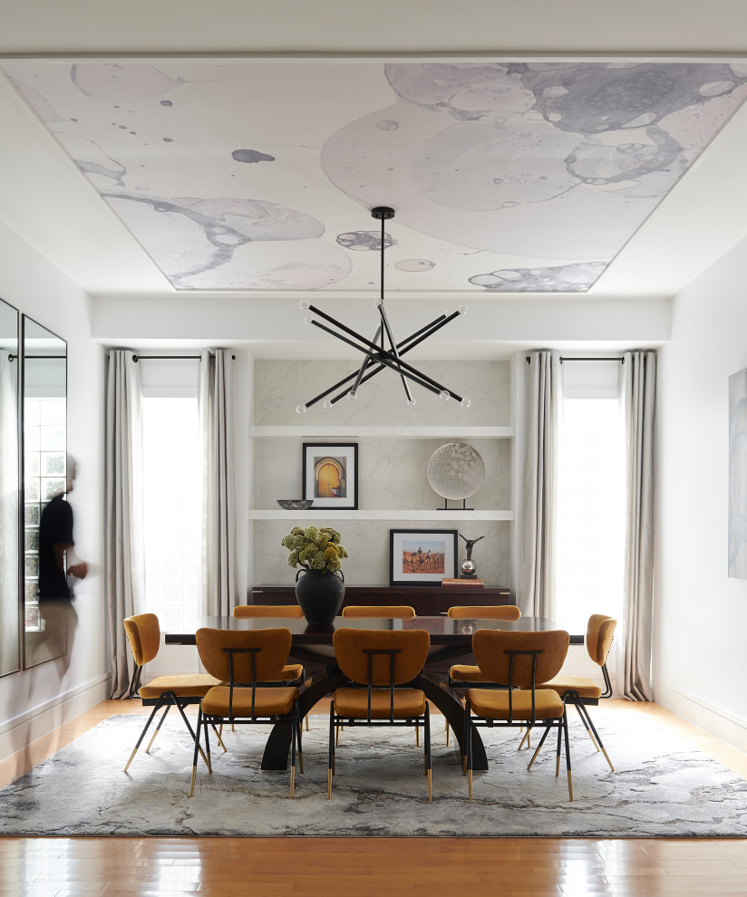 Large trendy light wood floor and wallpaper ceiling enclosed dining room photo in Toronto with white walls