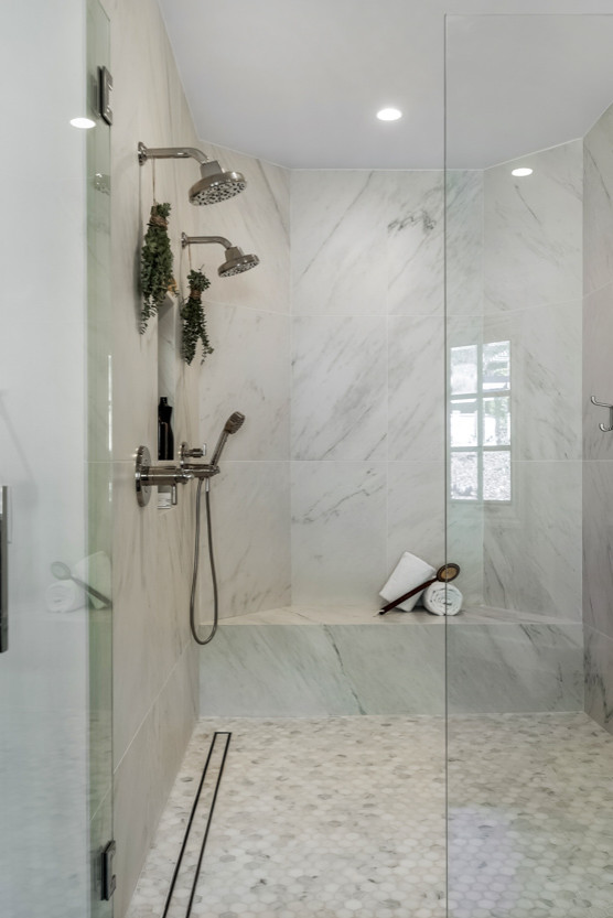 Photo of an expansive transitional master bathroom in Los Angeles with shaker cabinets, medium wood cabinets, a freestanding tub, an alcove shower, a wall-mount toilet, white tile, porcelain tile, white walls, marble floors, an undermount sink, white floor, a hinged shower door, white benchtops, a shower seat, a single vanity and a built-in vanity.