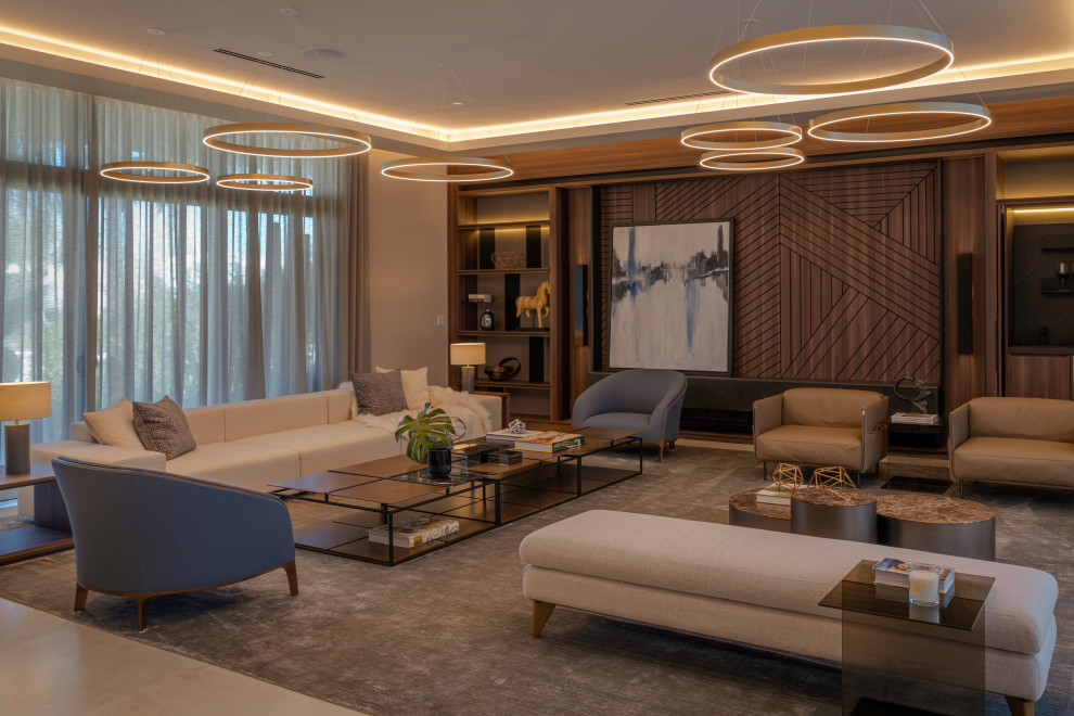 Photo of an expansive modern formal open concept living room in Other with brown walls, dark hardwood floors, a concealed tv, recessed and wallpaper.
