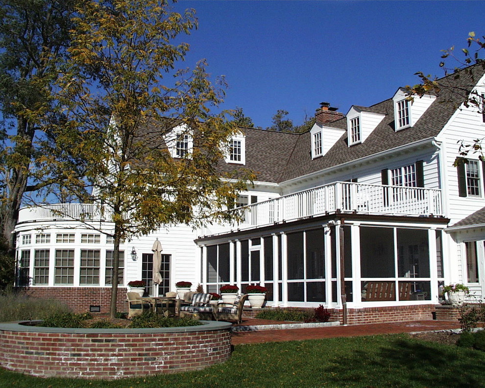 Photo of a large traditional two-storey white house exterior in Baltimore with vinyl siding, a gable roof and a shingle roof.