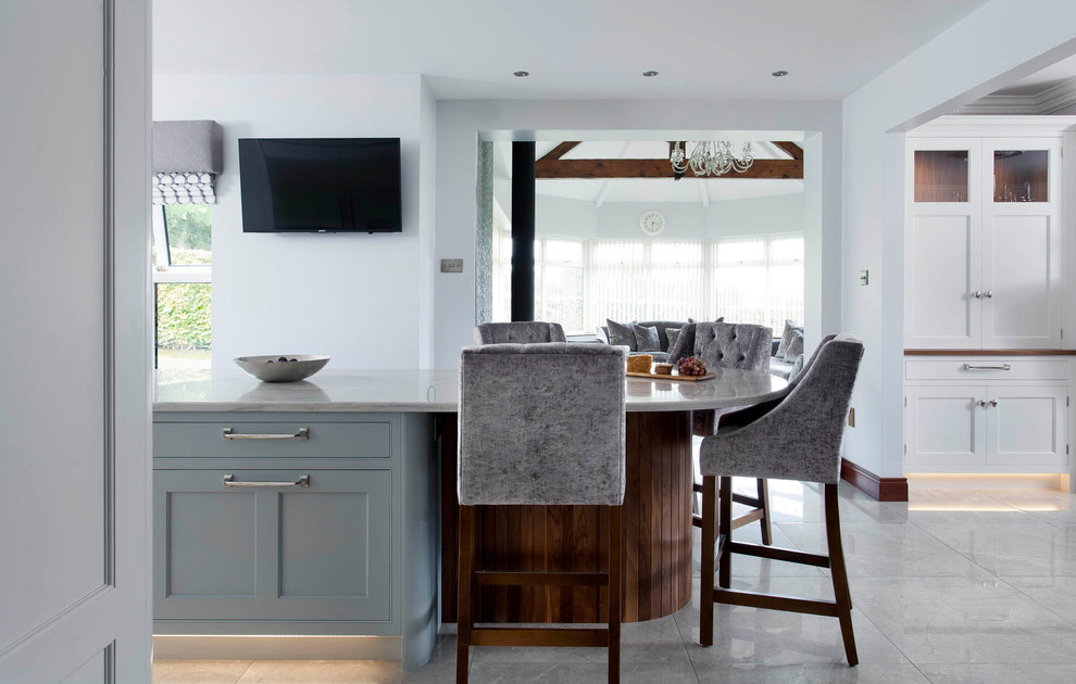 Design ideas for a mid-sized transitional l-shaped open plan kitchen in Other with an integrated sink, shaker cabinets, blue cabinets, marble benchtops, grey splashback, marble splashback, stainless steel appliances, porcelain floors, with island and grey floor.