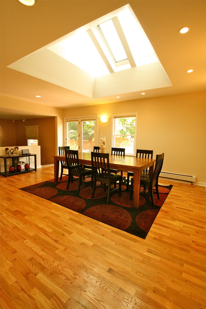 Photo of a traditional separate dining room in Denver with beige walls and light hardwood floors.