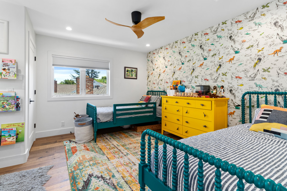 Design ideas for a mediterranean kids' room for boys in Sacramento with multi-coloured walls, medium hardwood floors, brown floor and wallpaper.
